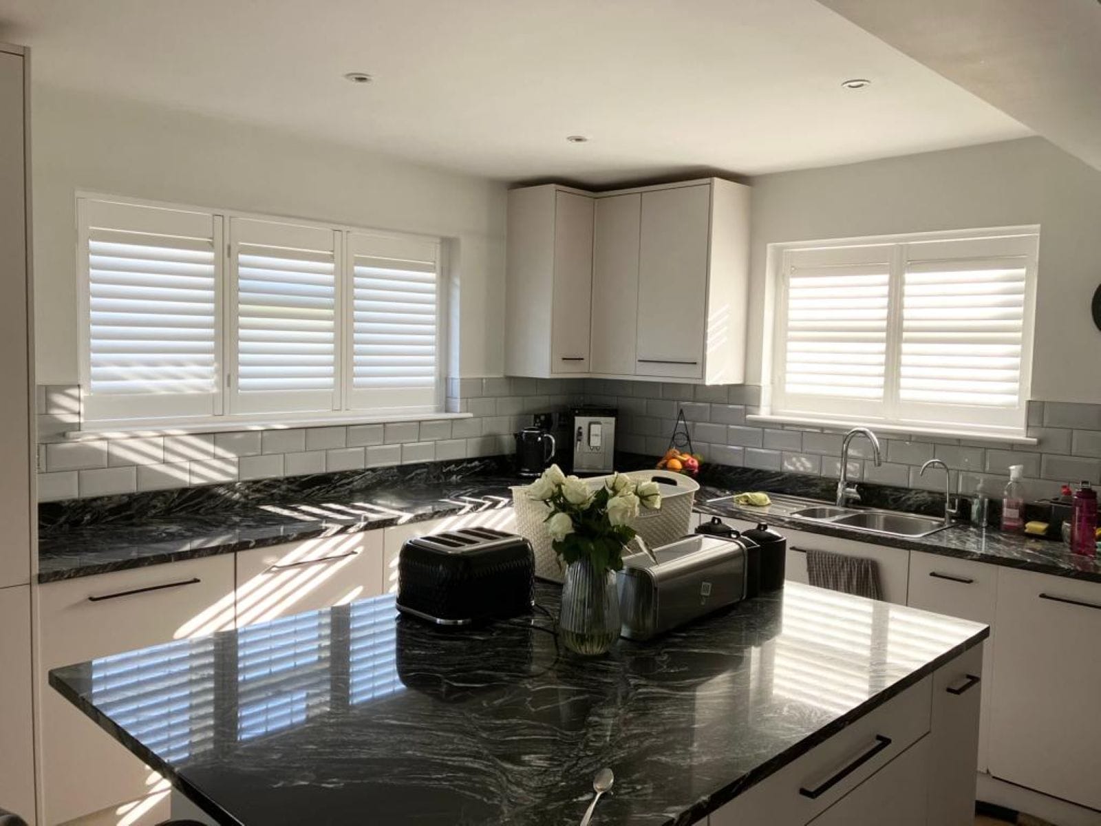 Madison Hardwood plantation shutters in cloud finish fitted in a bright Essex home, combining style and precision.
