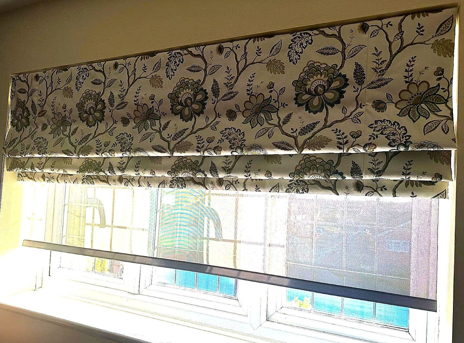 Made-to-measure floral Roman Blind installed in an Essex home, featuring soft folds and a patterned fabric that complements the interior décor.