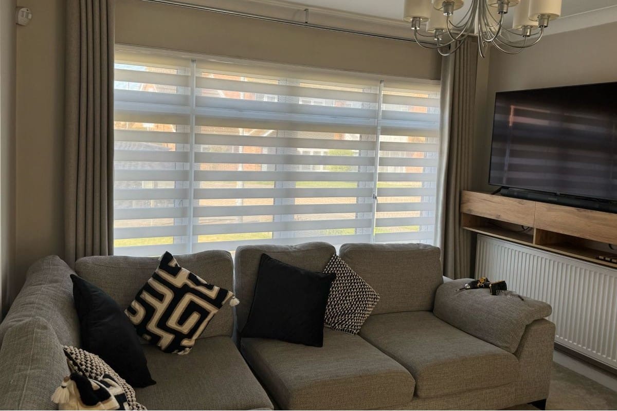 Ferrara Linen cassette vision blinds (day and night blinds) fitted across a wide living room window, providing adjustable light control with a soft layered design.