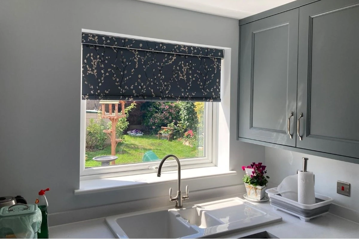 Navy Floral Cassette Roller Blind in Kitchen Window Navy floral cassette roller blind fitted inside a kitchen window above a sink