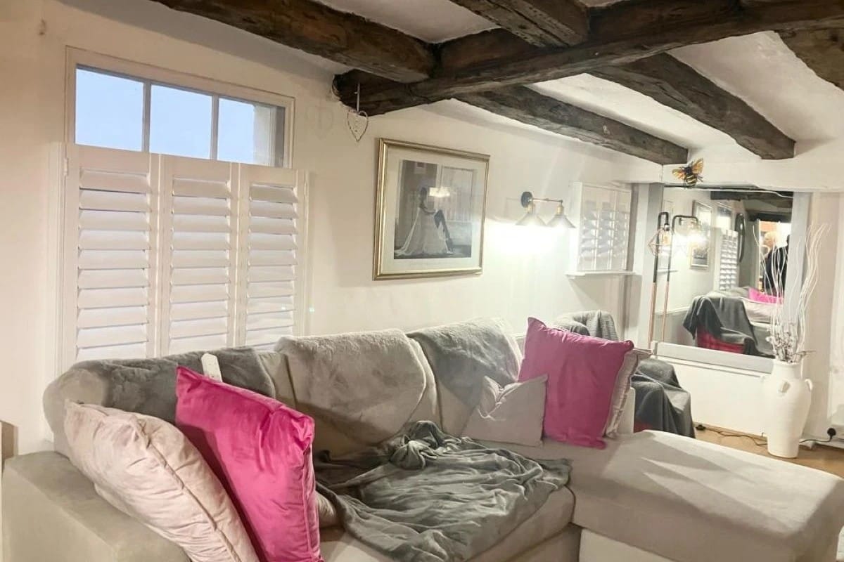 Café style plantation shutters installed on a living room window