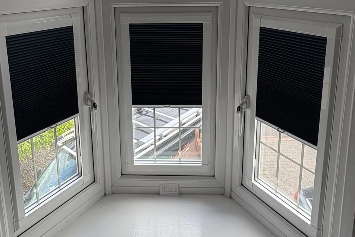Perfect Fit Blackout Cellular Blinds in Bedroom Bay Window Perfect Fit blackout cellular blinds fitted to a white uPVC bay window in a bedroom.