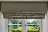 Roman blind with matching pelmet fitted in a bedroom window