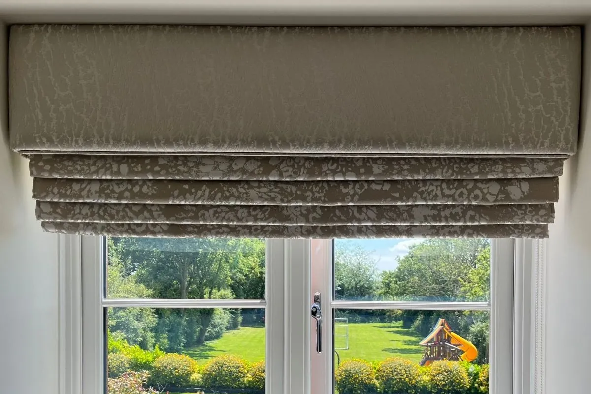 Roman blind with matching pelmet fitted in a bedroom window