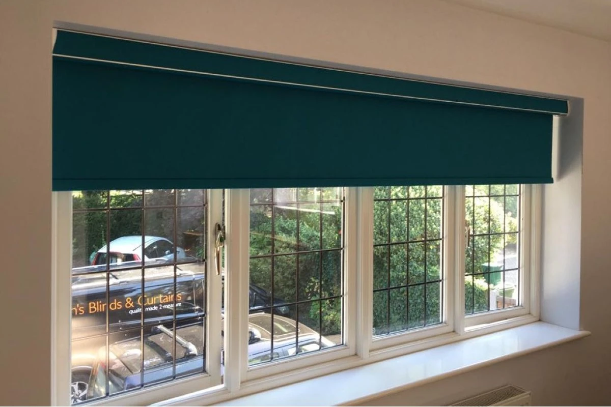 Teal Blackout Roller Blind in Bedroom Teal blackout roller blind fitted in a bedroom window