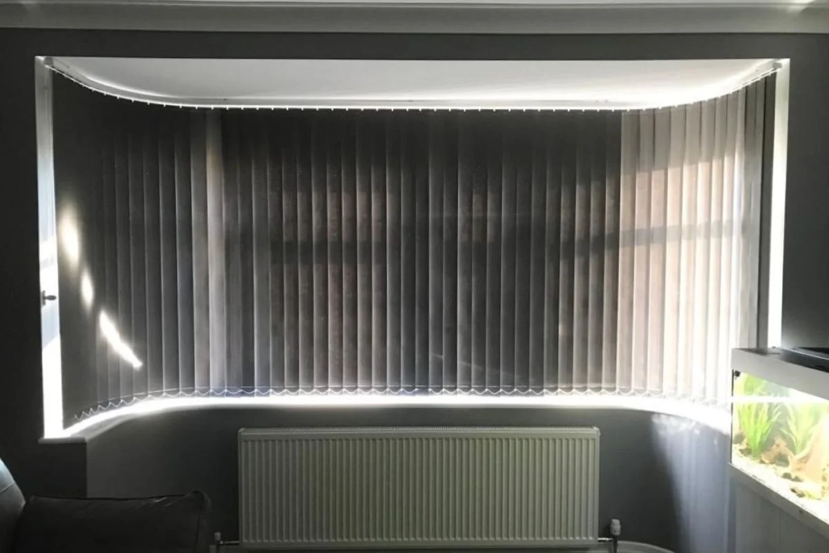 Vertical blinds fitted to a splay bay window using a curved track, providing smooth operation, privacy, and controlled natural light