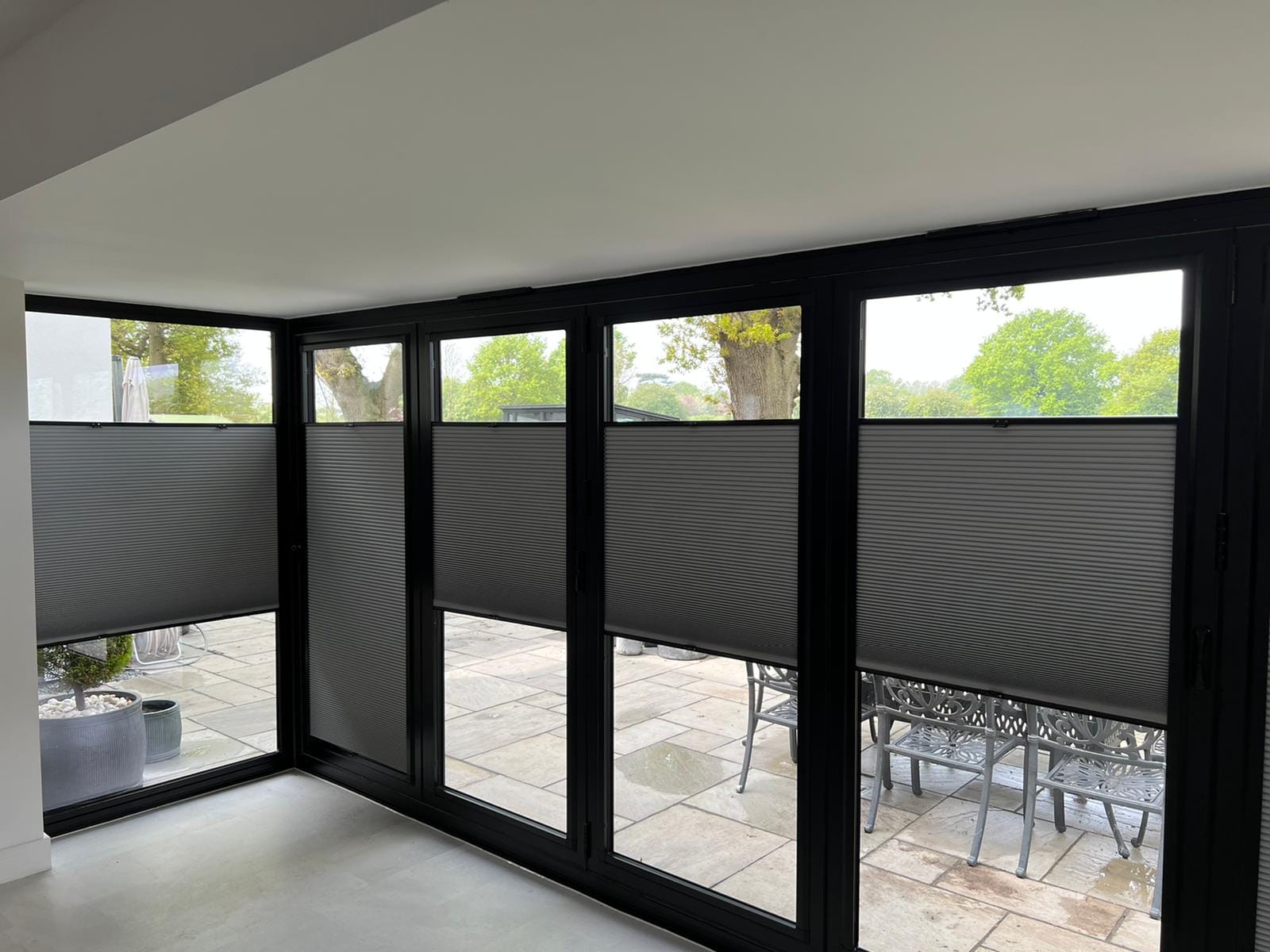 Perfect Fit multi-zone cellular no-drill blinds fitted to black aluminium bifold doors