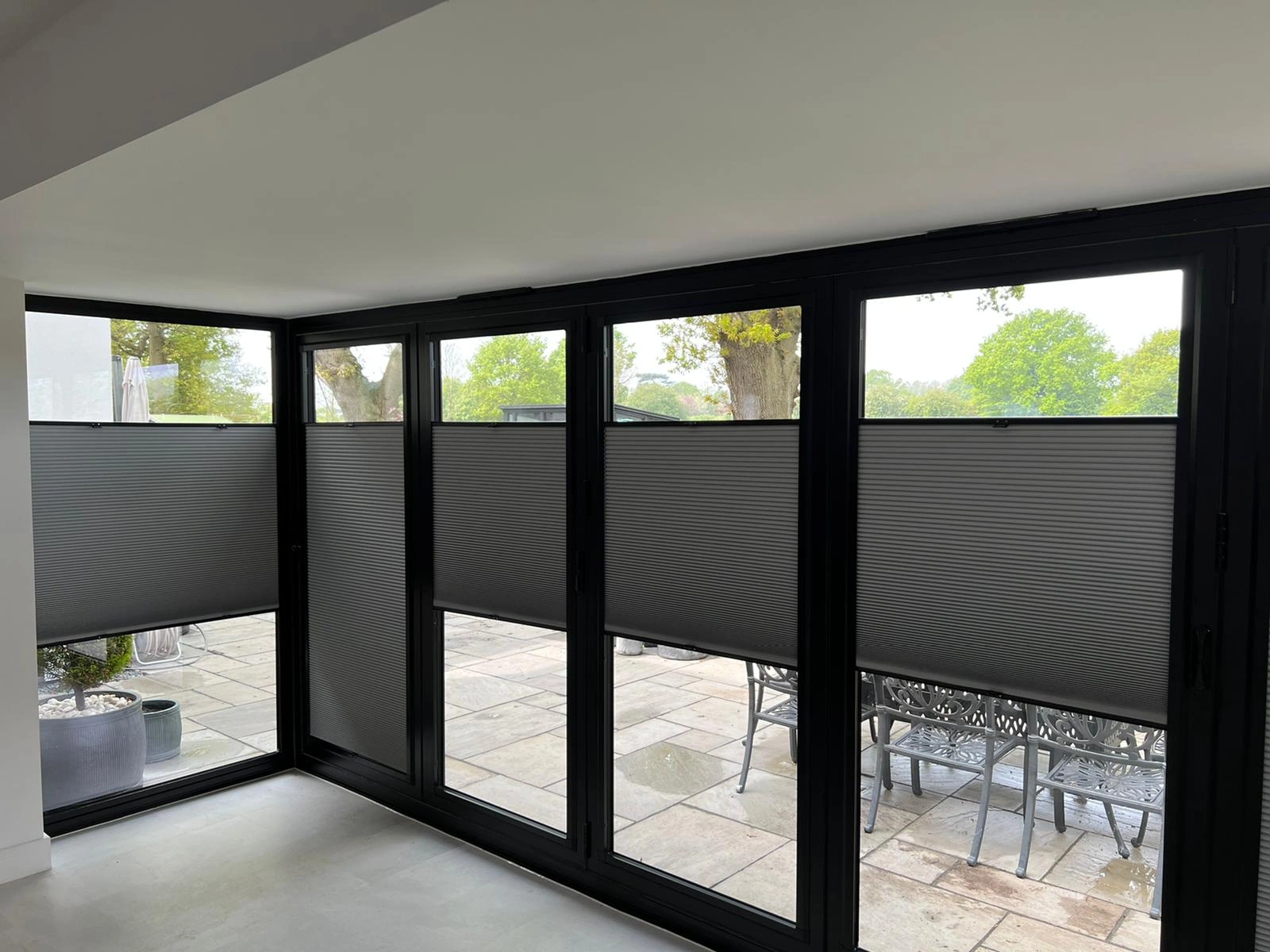 Perfect Fit multi-zone cellular blinds fitted to black bifold doors without drilling