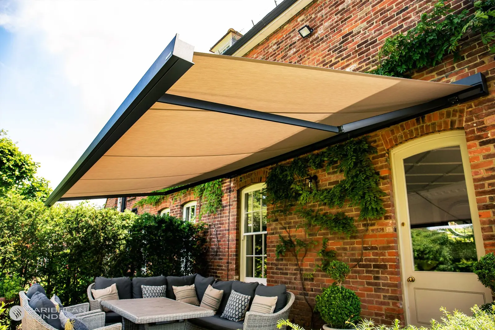 Cuba patio awning extended over seating area showing strong aluminium folding arms