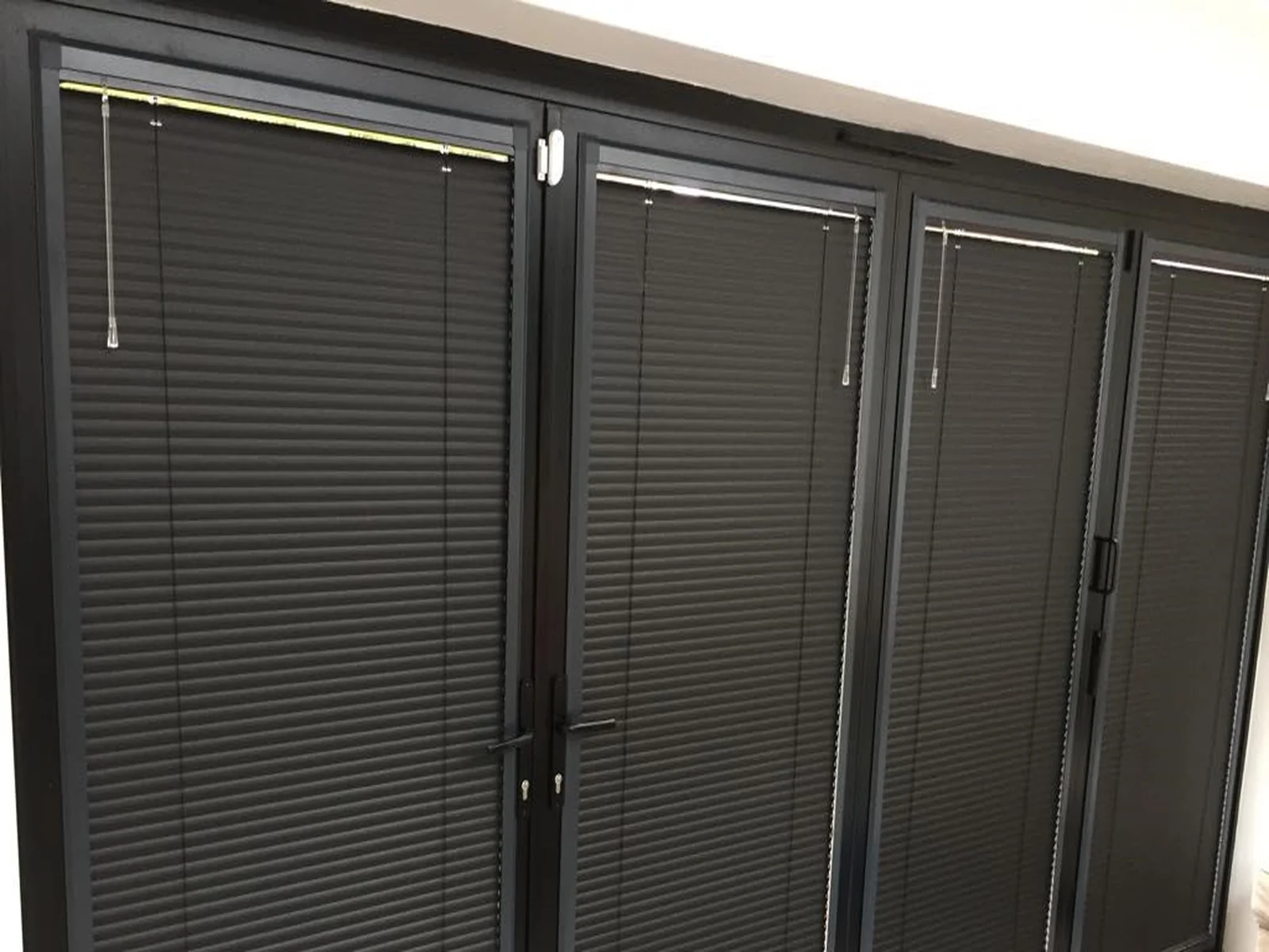 Perfect Fit blinds fitted to black bifold doors with no drilling