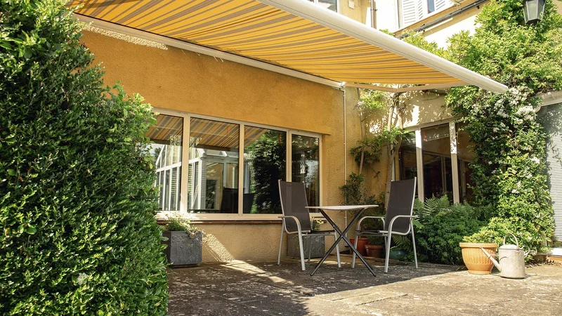 Striped Tortola patio awning installed on a residential home