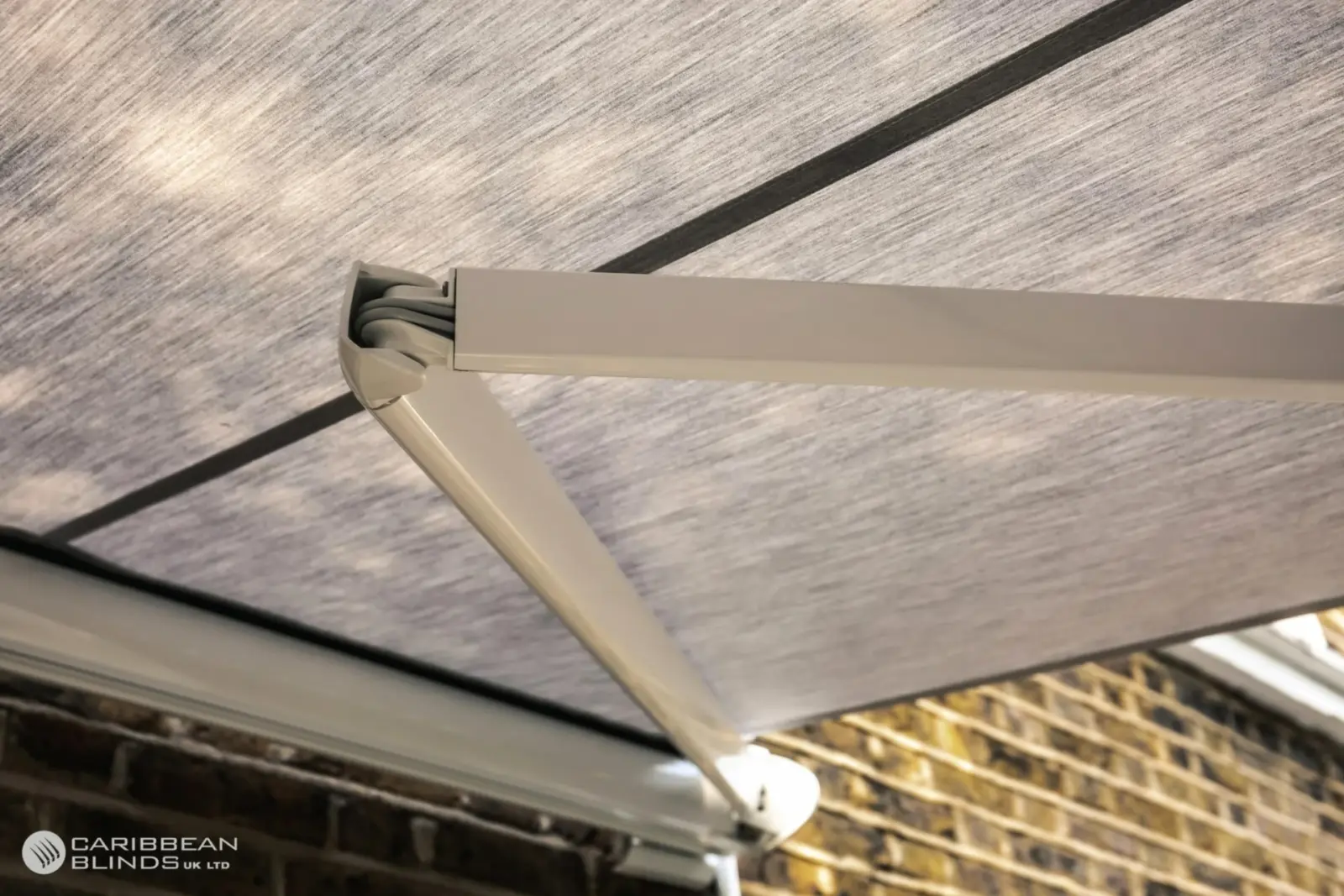 Underside view of Tortola awning fabric showing tensioned folding arm system