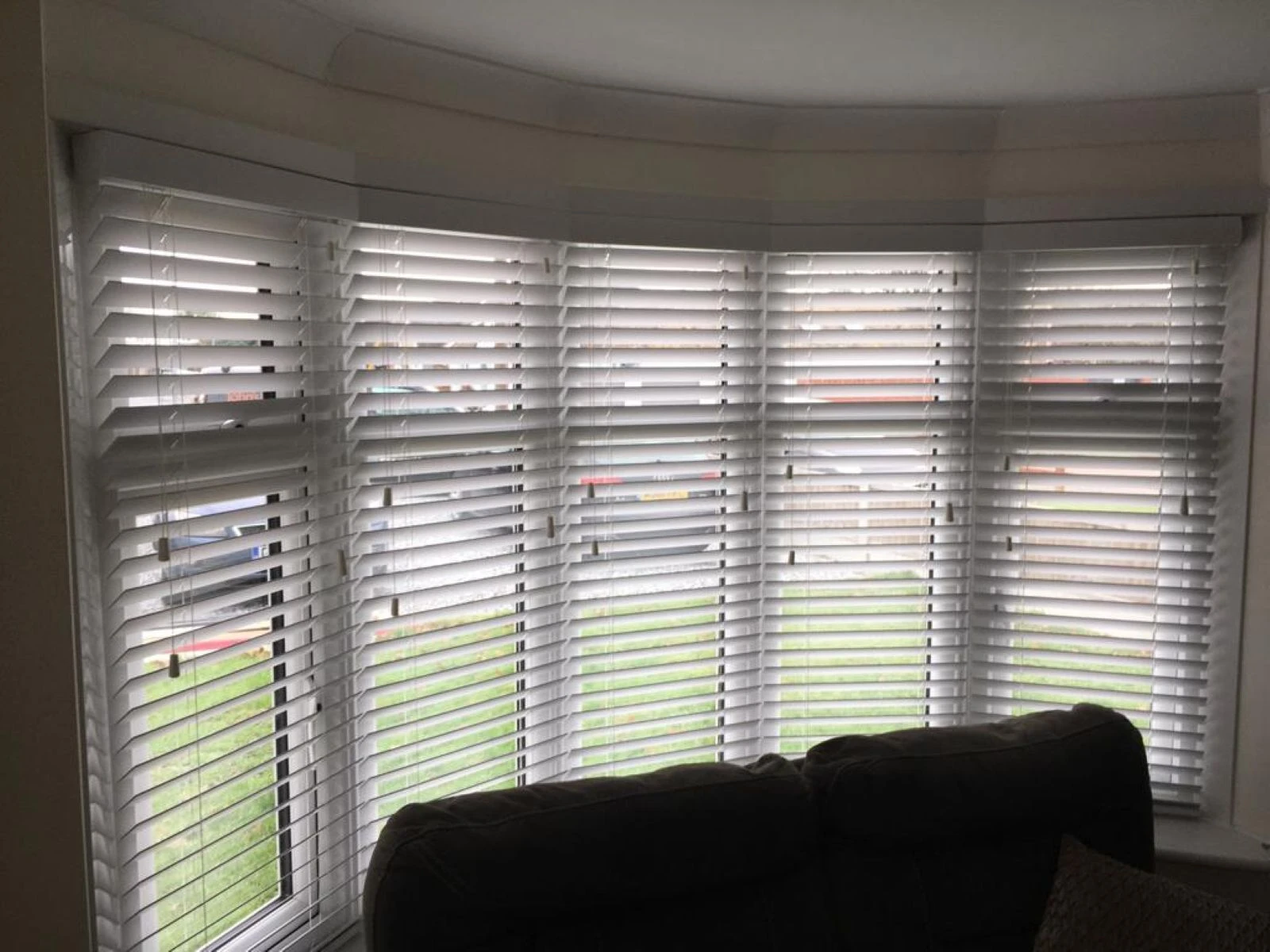 White 50mm PVC Venetian blinds fitted across a bay window, offering adjustable light control and privacy.