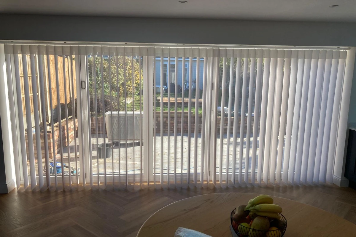 Allusion blinds installed across bifold doors in a living room - made in Wickford