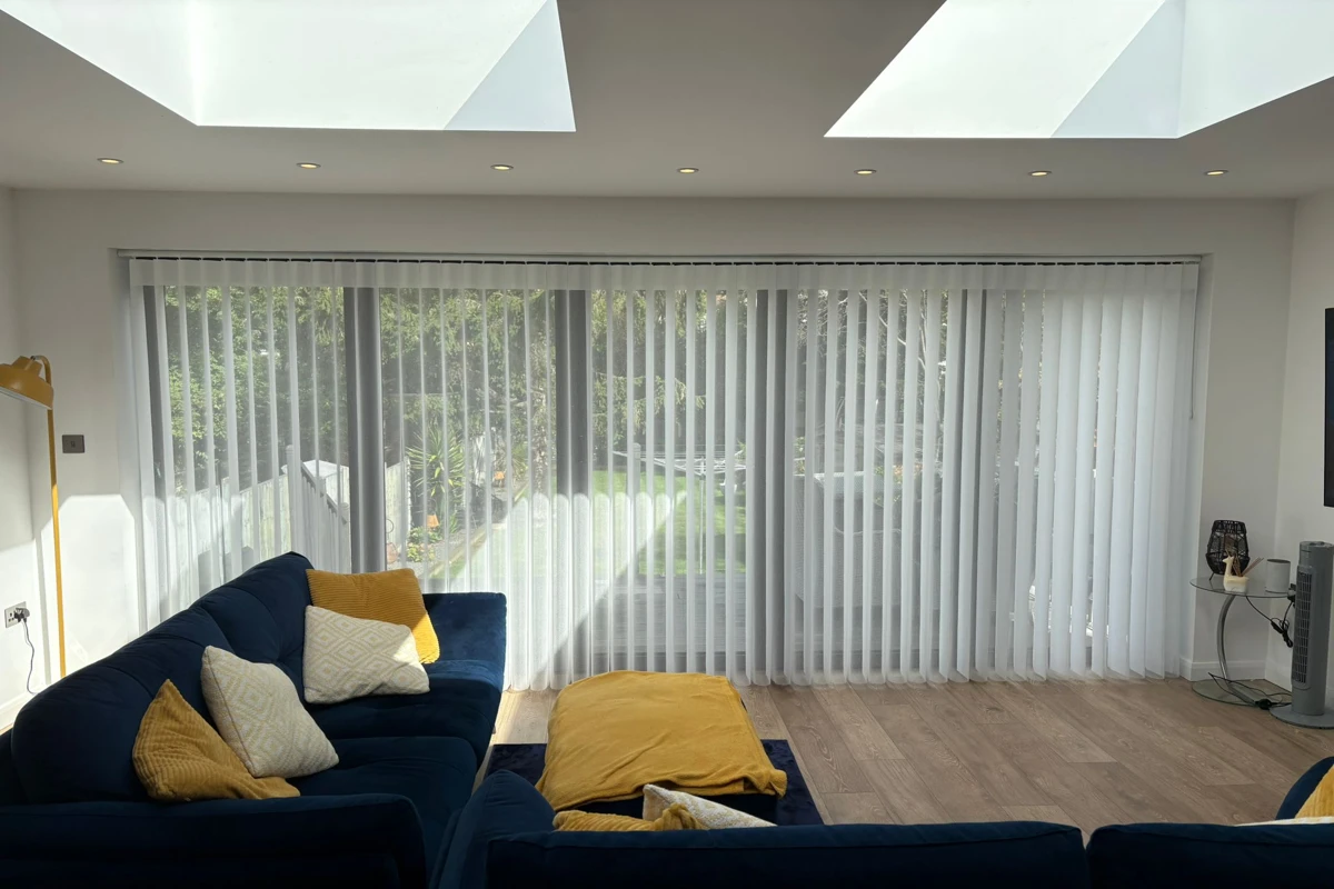 Allusion blinds installed across wide bifold doors in a living room - made in Wickford