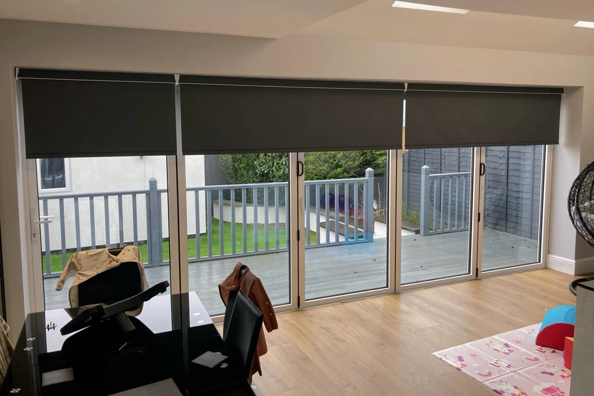 blackout roller blinds installed above bifold doors, inside the recess