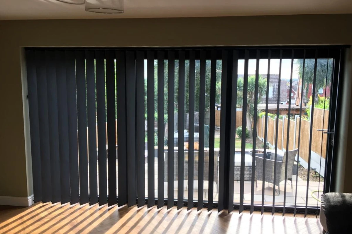 charcoal vertical blinds installed across bifold doors - made in Wickford