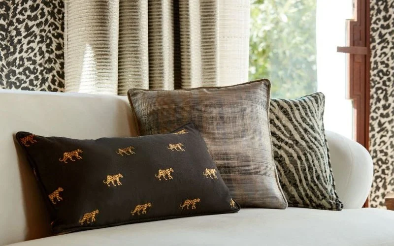 Decorative cushions with coordinating curtain accessories including fabrics, tiebacks and soft furnishings