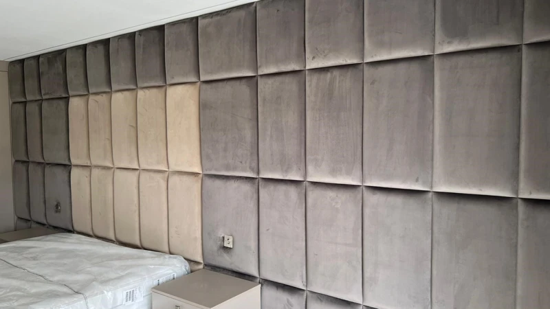 Made to measure padded wall panels installed in a bedroom in Essex for a soft, upholstered feature wall finish