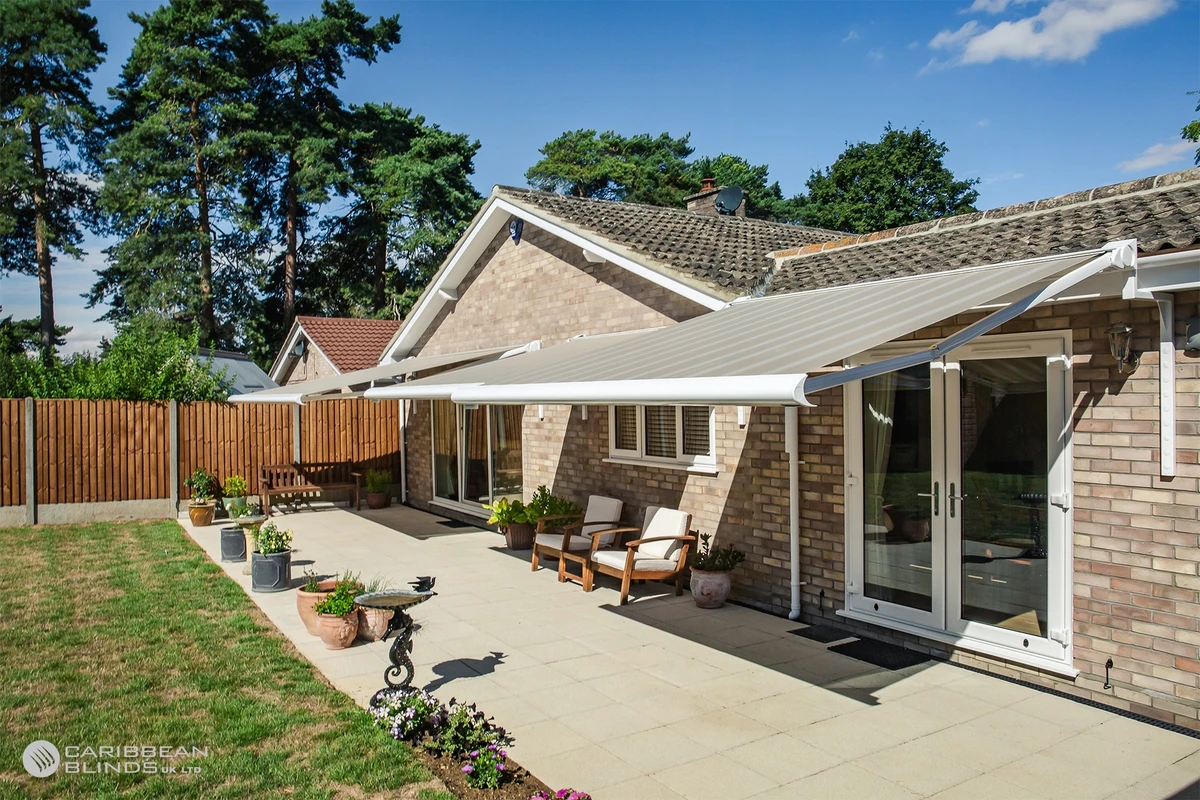 Retractable awning providing shade over a garden patio at a residential property