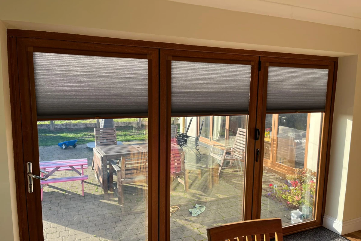 Perfect Fit cellular blinds installed on light oak uPVC bifold doors