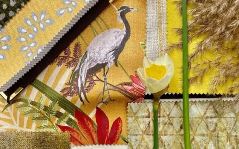 Patterned yellow curtain fabric samples with floral and nature-inspired designs