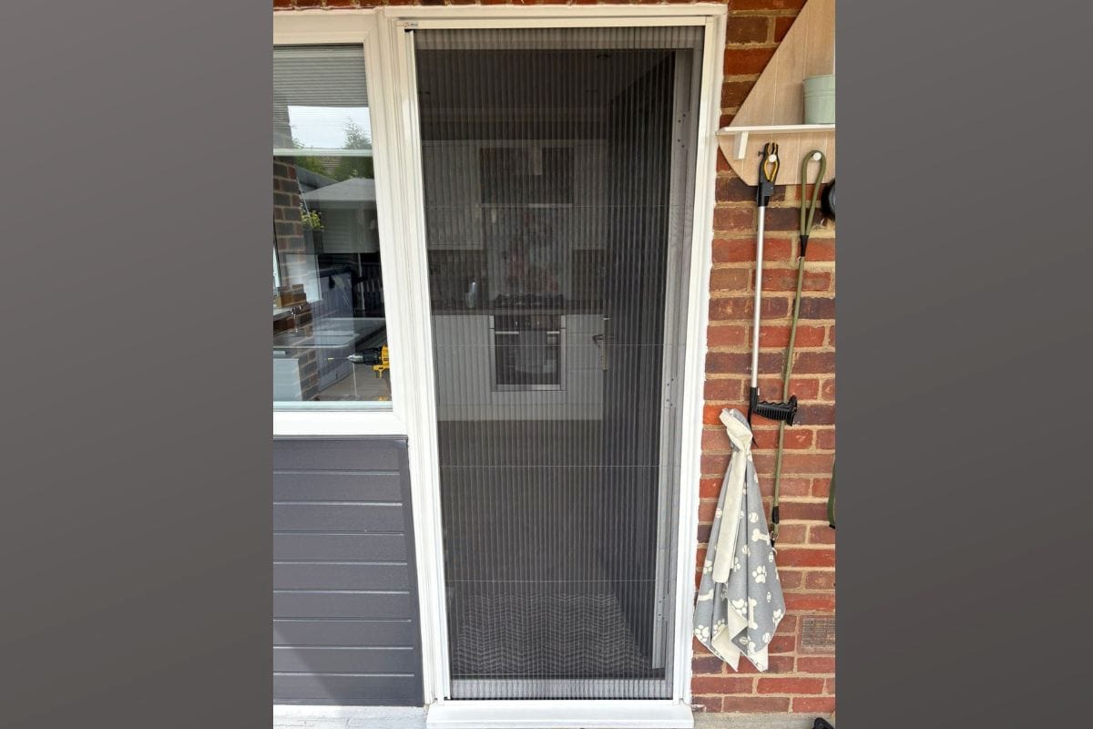 Fly screen fitted to a back door using a made-to-measure blind screen system in a UK home