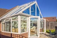 Glass conservatory roof allowing strong sunlight and heat into the space