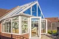 Glass conservatory roof allowing strong sunlight and heat into the space