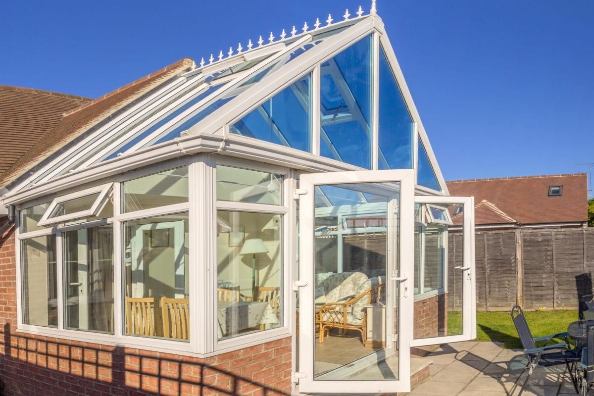 Glass conservatory roof allowing strong sunlight and heat into the space