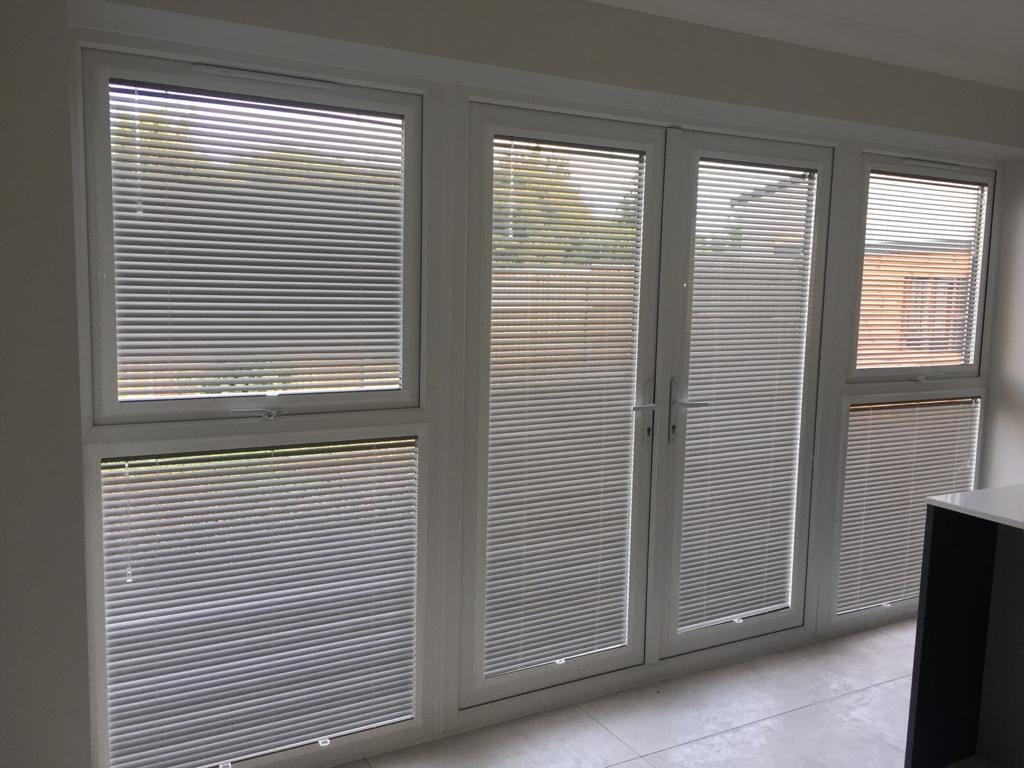 Perfect fit no drill blinds installed on uPVC windows and patio doors in a modern home