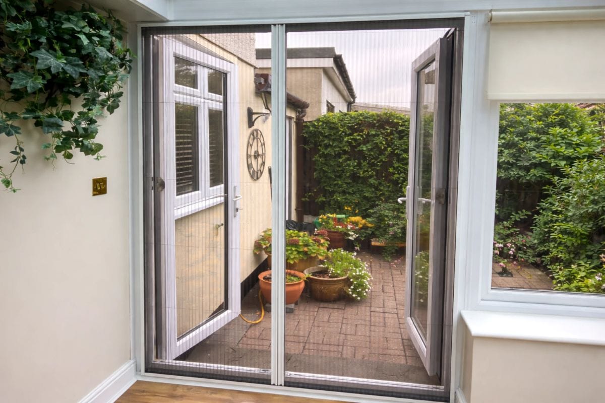 Retractable Blind Screen fly screen fitted to conservatory patio doors allowing fresh air in while keeping insects out