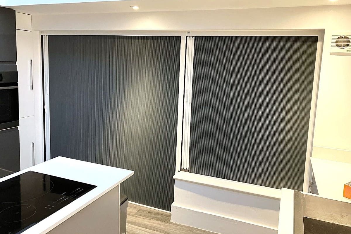 Blackout blind screens fitted to windows, reducing light and improving room light control