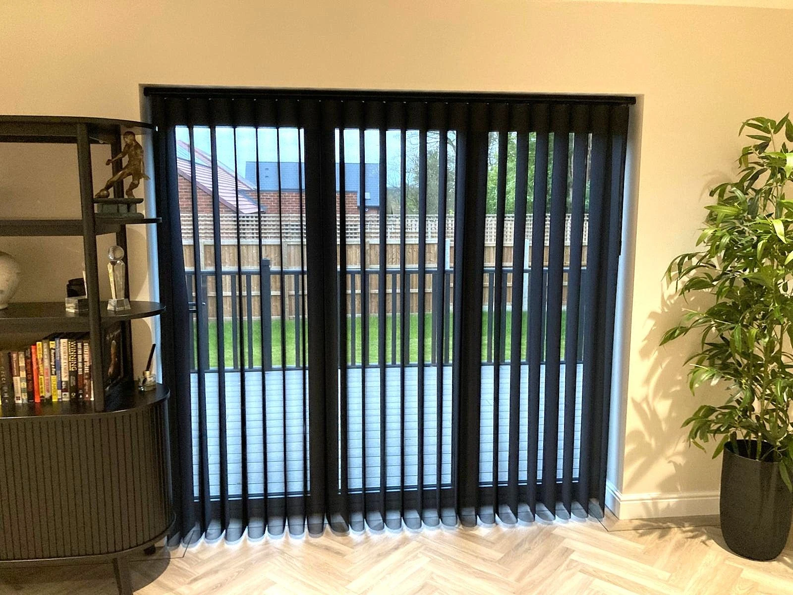 Allusion Blinds for Bifold Doors Black Allusion blinds installed on modern bifold doors in a contemporary open-plan home.