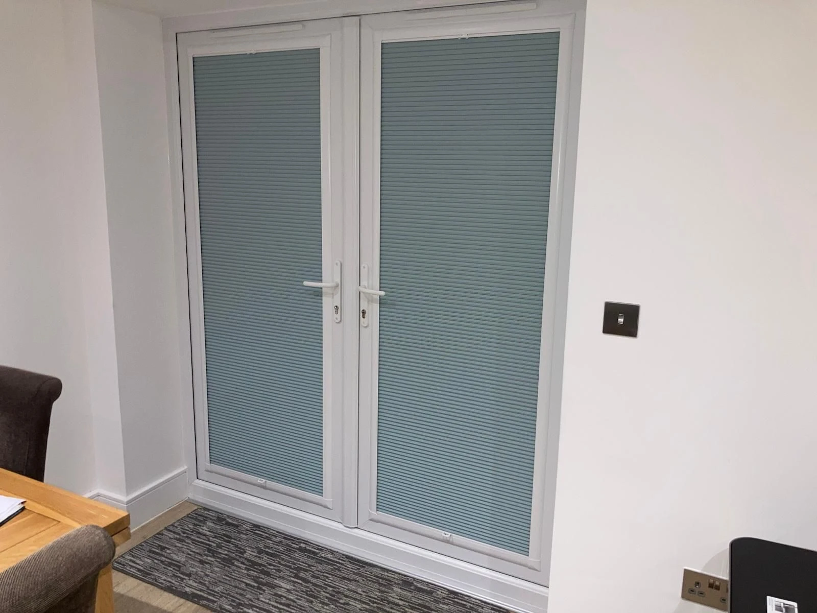 Perfect Fit Cellular Blinds fitted within glazed doors in a modern home interior.