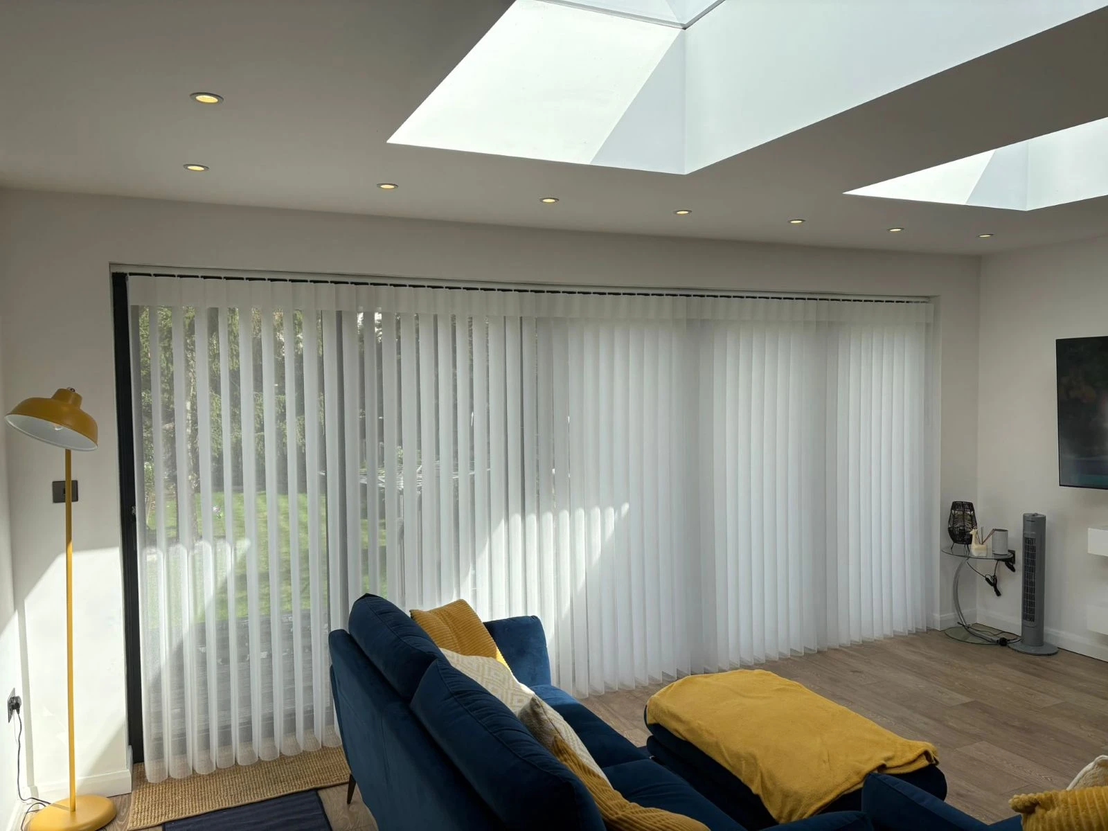 Allusion Blinds for Modern Extensions White Allusion blinds installed across large glazed doors in a modern home extension with roof lanterns and open-plan living space.