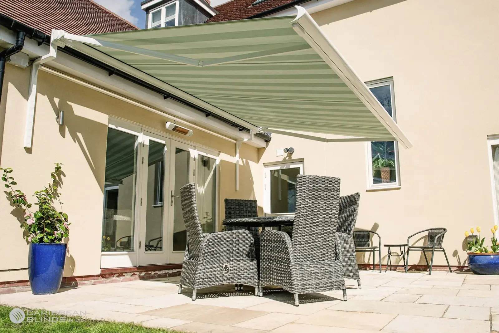 Retractable patio awning shading outdoor dining set on patio at Essex home