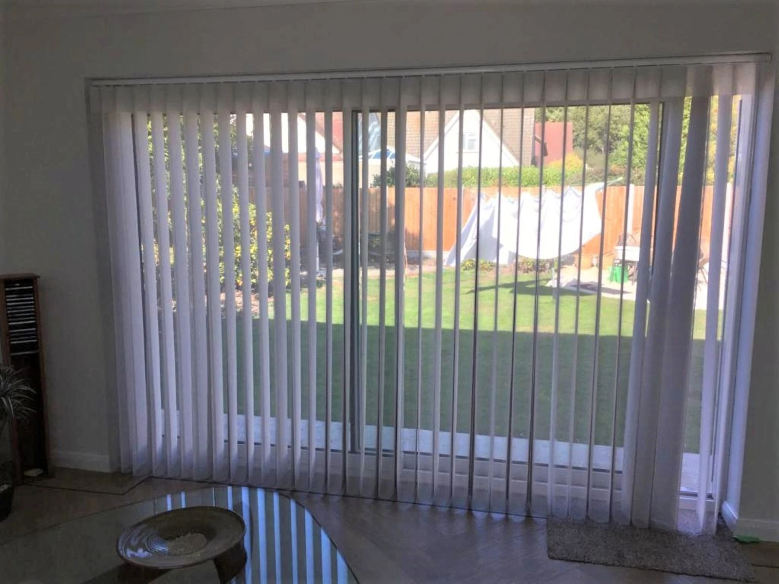 Allusion Blinds for Patio Doors White Allusion blinds installed on large patio doors in a modern open-plan living space.