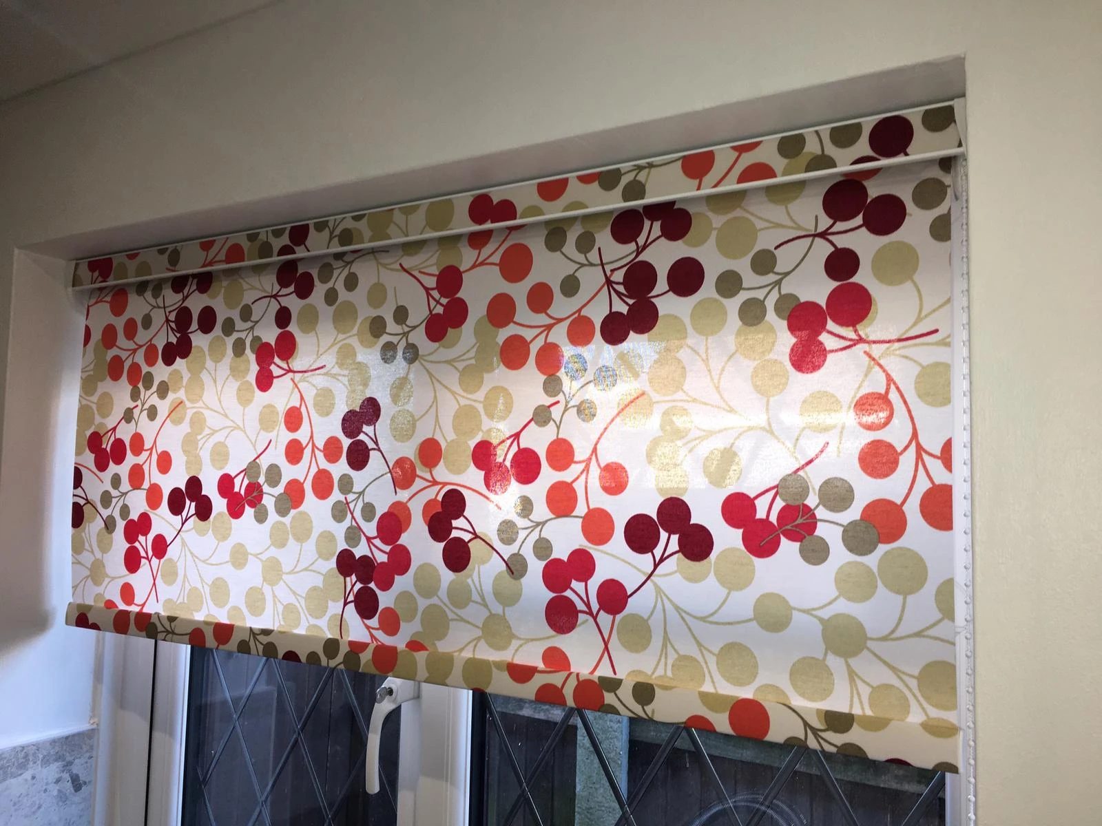 Patterned translucent roller blind fitted within a modern kitchen window in an Essex home.