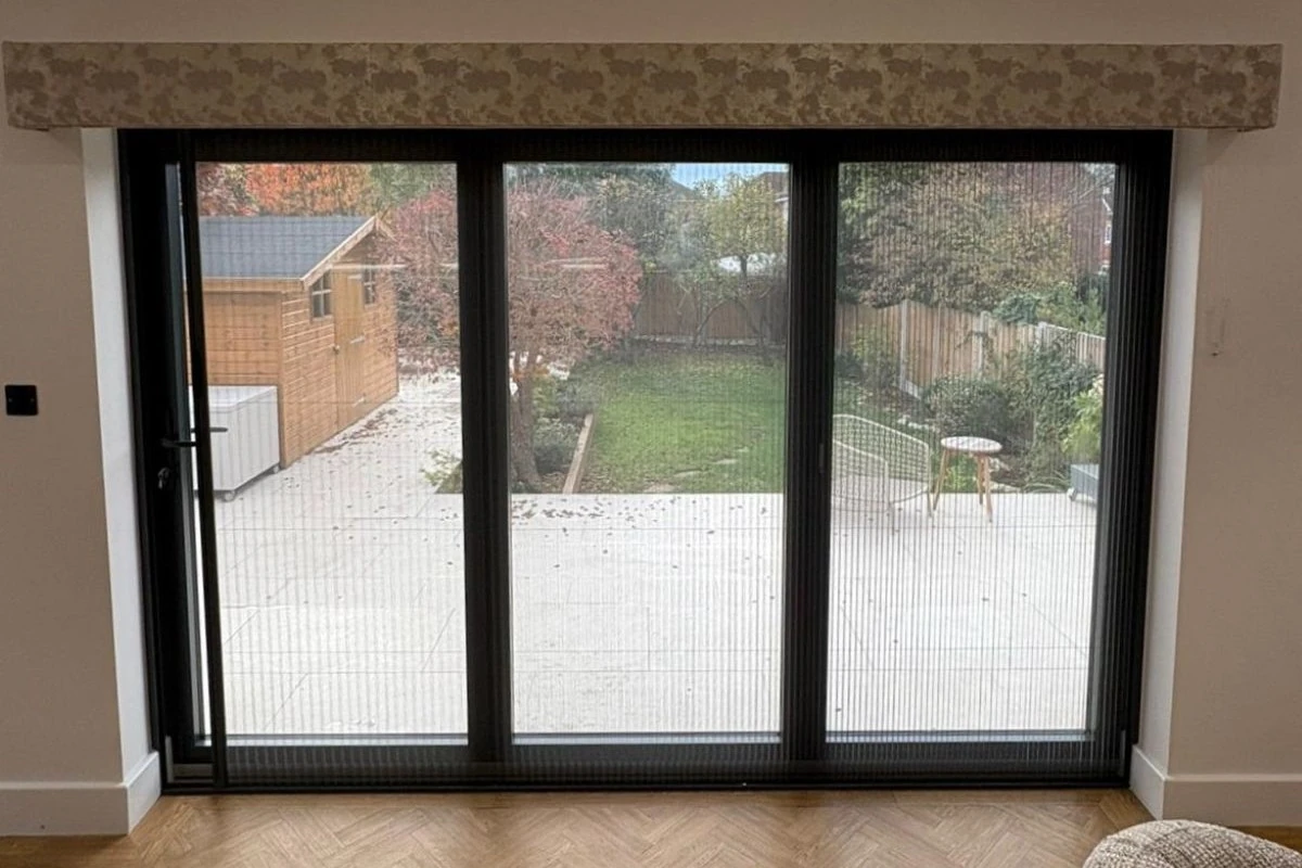 Fly screen fitted across patio doors to allow fresh air into the home while helping keep insects outside.
