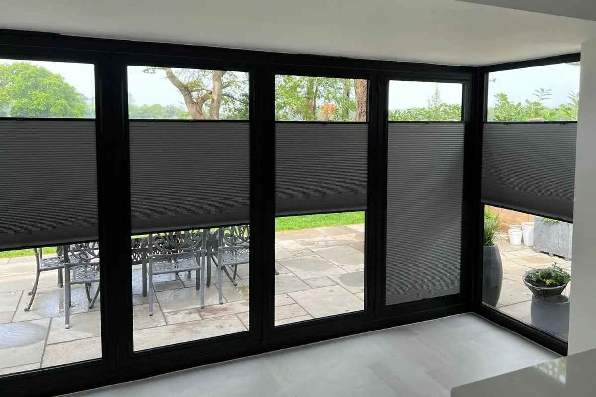 Perfect Fit Cellular Blinds for Bifold Doors Grey Perfect Fit Cellular Blinds made in Wickford and fitted to black bifold doors with top-down and bottom-up light control.