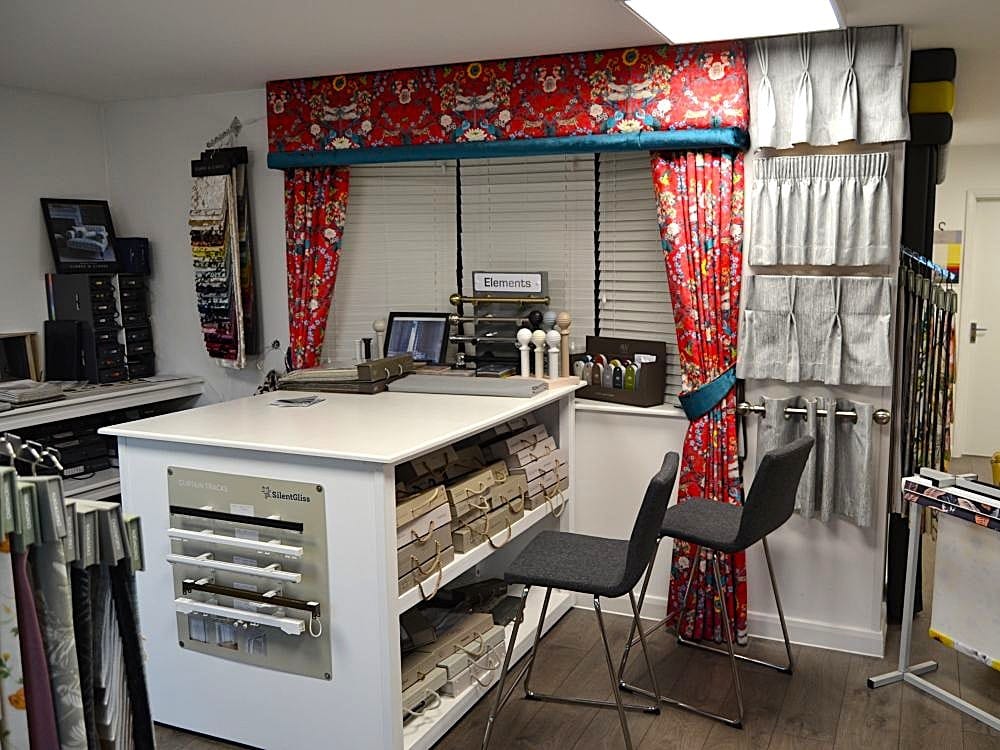 Curtain consultation area in John’s Blinds & Curtains’ Wickford showroom with fabric samples, heading styles, Venetian blinds, poles and tracks.