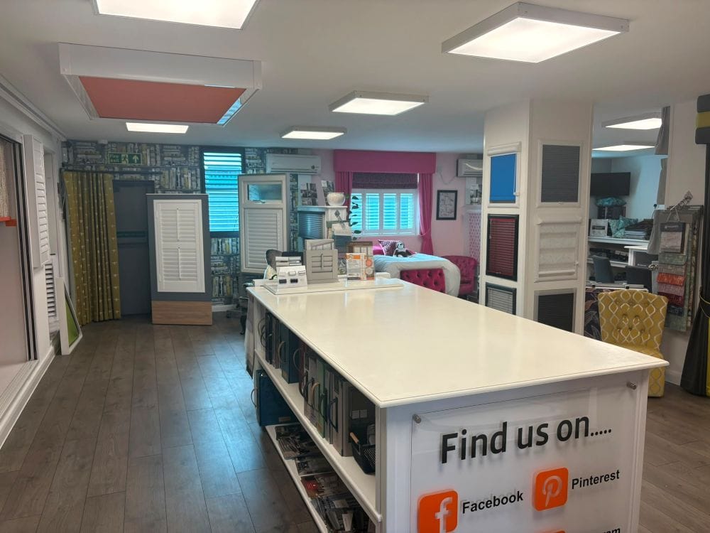 Wide interior view of John’s Wickford showroom with roof lantern blind, plantation shutter, curtain and window blind displays.